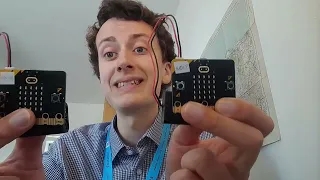 Picture of Mr Morrison holding two micro:bits up.