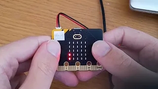 Picture of micro:bit with two dots on screen representing part of a game.